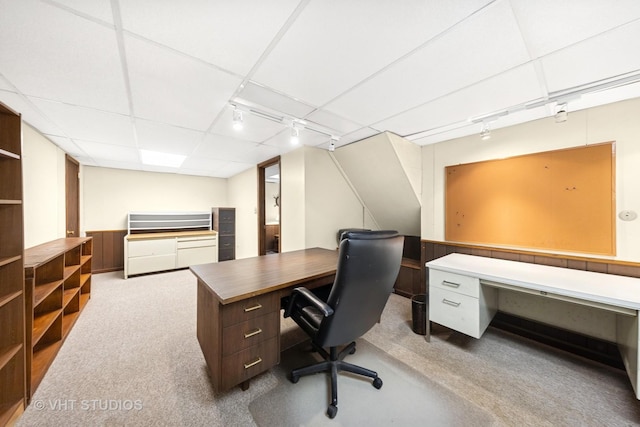 office area with a drop ceiling and track lighting