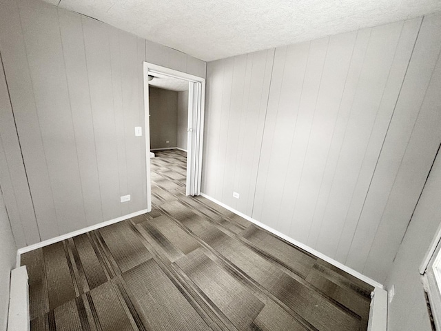 unfurnished room featuring a textured ceiling