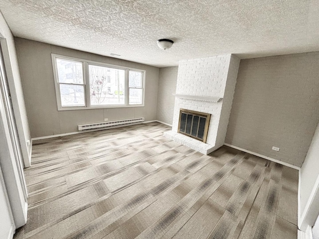 unfurnished living room with a baseboard radiator, wood-type flooring, a textured ceiling, and a fireplace