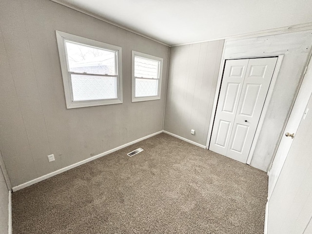 unfurnished bedroom featuring a closet and carpet