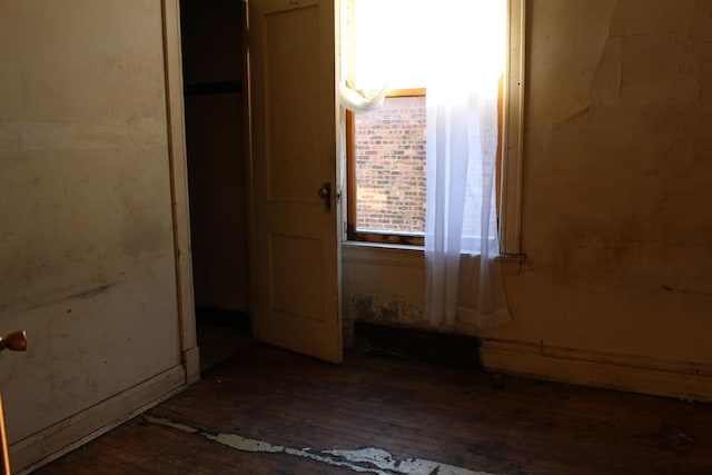 unfurnished bedroom featuring dark hardwood / wood-style flooring