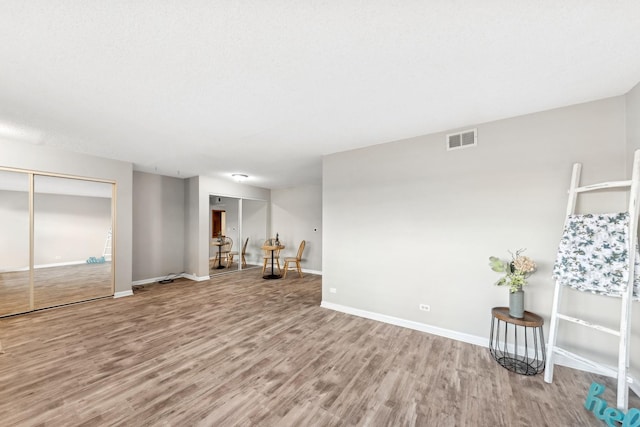 empty room with light hardwood / wood-style flooring