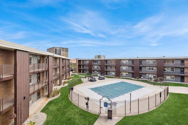 view of swimming pool with a lawn