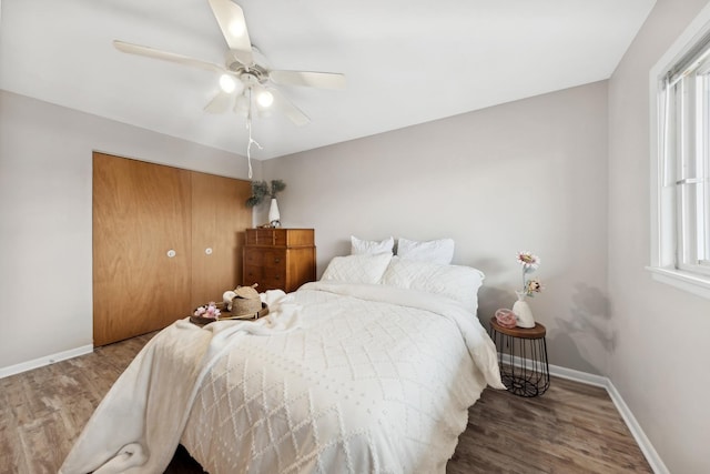 bedroom featuring hardwood / wood-style flooring, a closet, and ceiling fan