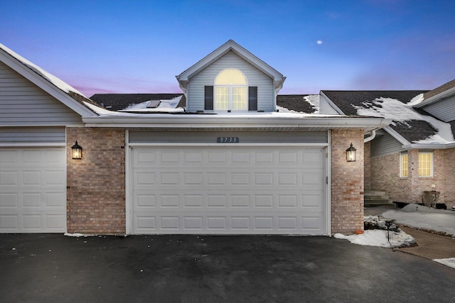 view of garage at dusk