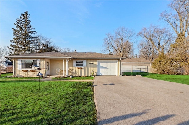 ranch-style home featuring a garage, driveway, a front lawn, and fence