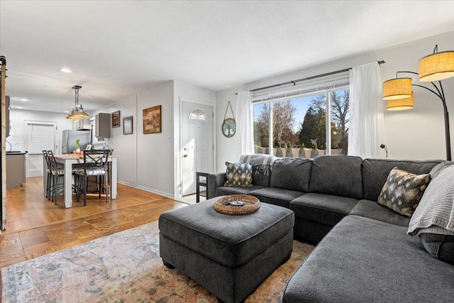 living room featuring wood finished floors and baseboards