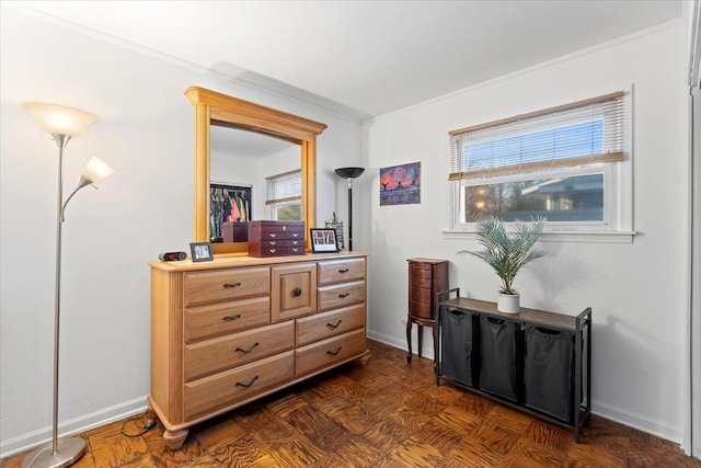 interior space featuring crown molding and baseboards