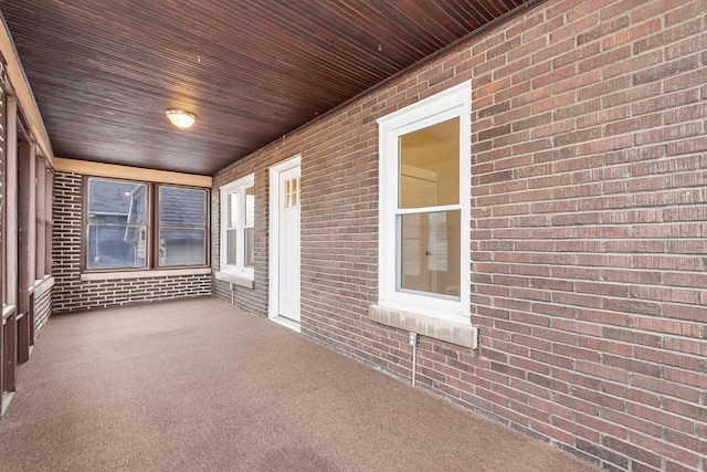 unfurnished sunroom featuring wooden ceiling