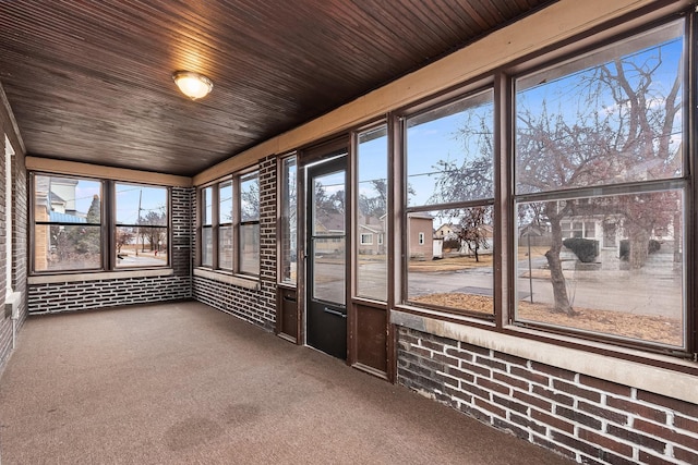 unfurnished sunroom with wooden ceiling