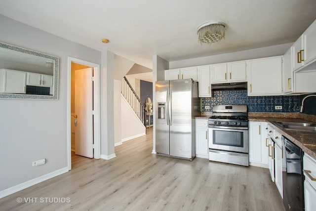 kitchen with stainless steel appliances, white cabinetry, a sink, and under cabinet range hood