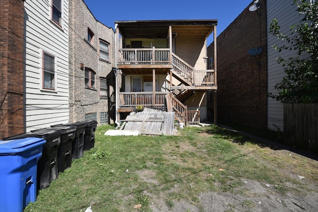 back of house featuring a yard and a deck