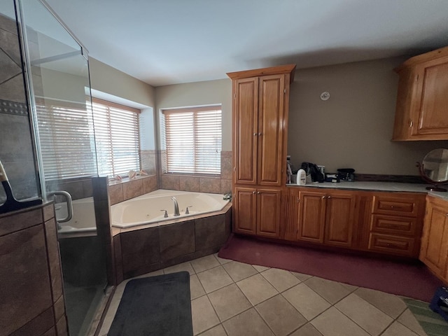 bathroom featuring tile patterned floors and independent shower and bath