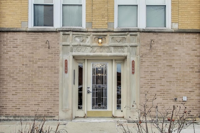 view of exterior entry with brick siding