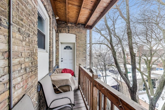 view of snow covered back of property