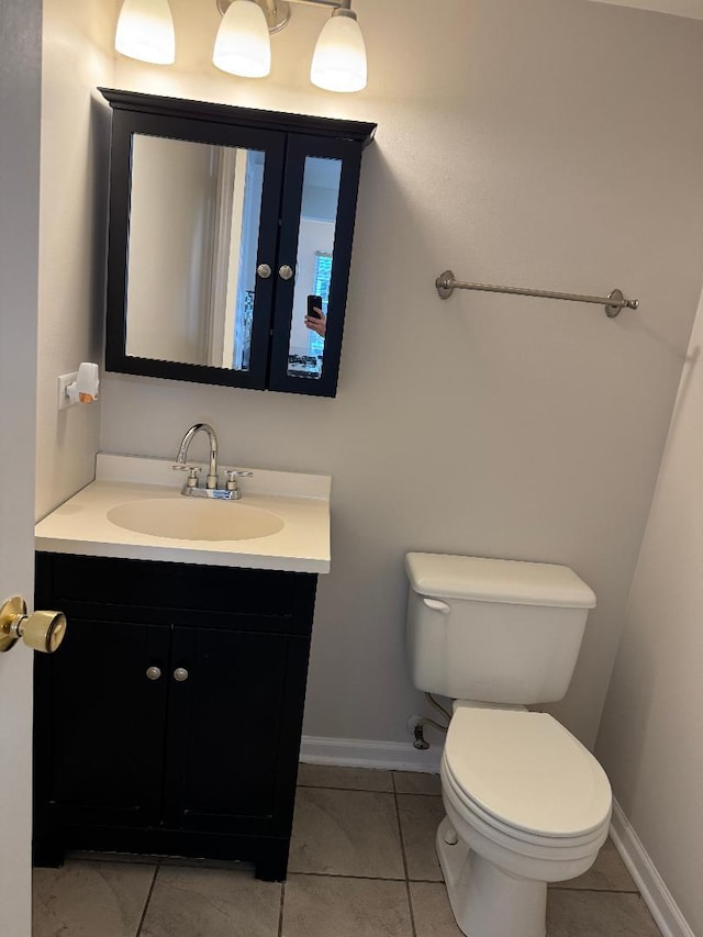 bathroom with vanity, tile patterned floors, and toilet