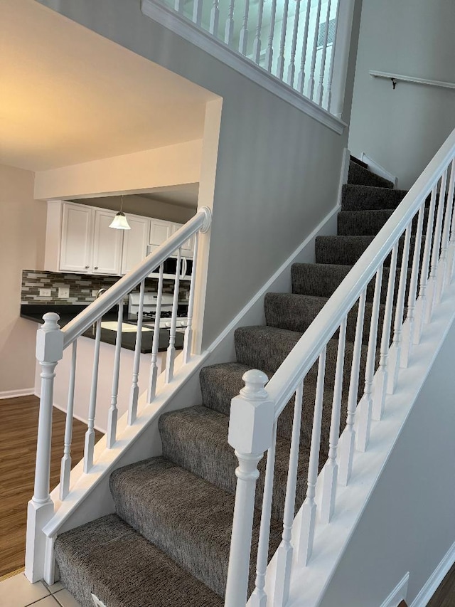 stairs featuring hardwood / wood-style flooring