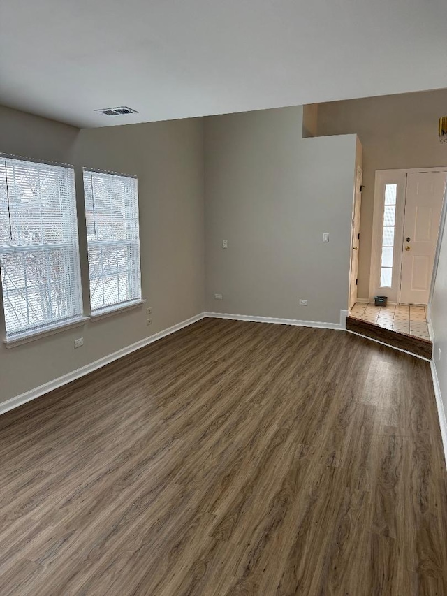 spare room featuring dark hardwood / wood-style flooring