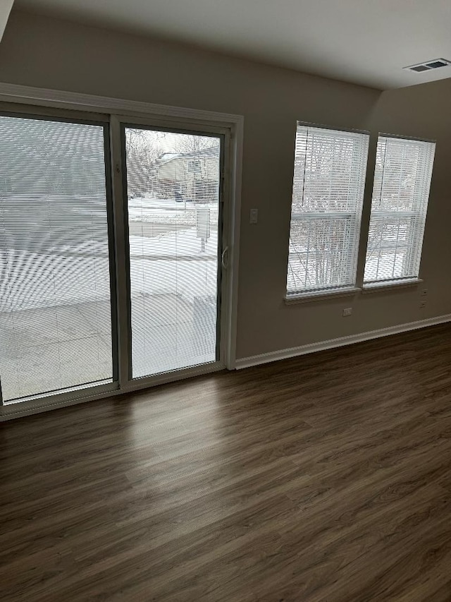 spare room with dark wood-type flooring