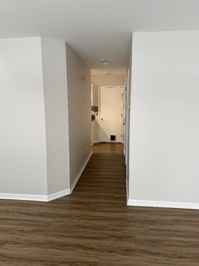 hallway with dark hardwood / wood-style flooring