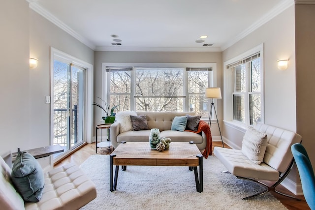 living room with light wood-style flooring, recessed lighting, visible vents, baseboards, and ornamental molding