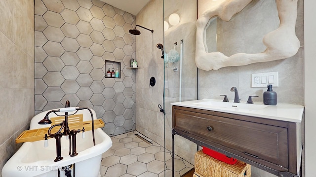 full bath with decorative backsplash, a tile shower, vanity, a freestanding tub, and tile walls