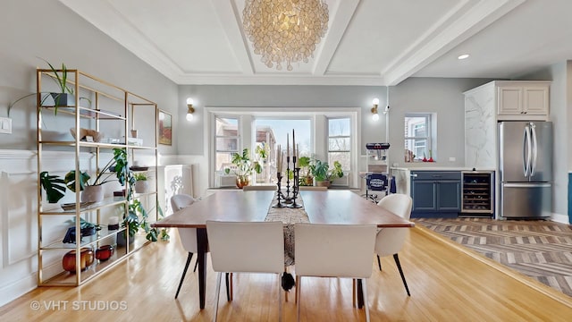 dining room with beverage cooler, light wood finished floors, coffered ceiling, and beam ceiling