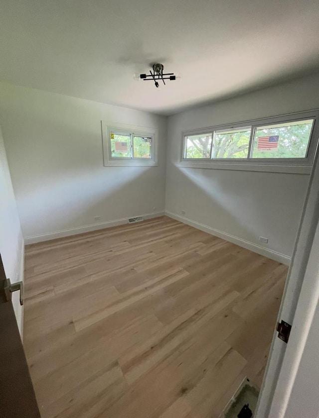 empty room with light hardwood / wood-style flooring