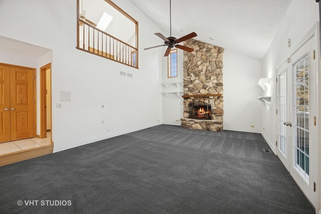 unfurnished living room with a fireplace, high vaulted ceiling, a textured ceiling, and dark colored carpet