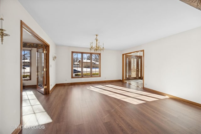 unfurnished dining area featuring dark wood-type flooring and an inviting chandelier