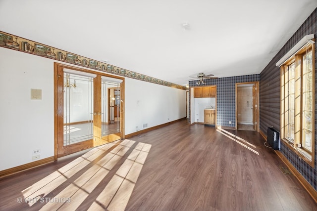 unfurnished living room with dark wood-type flooring and ceiling fan