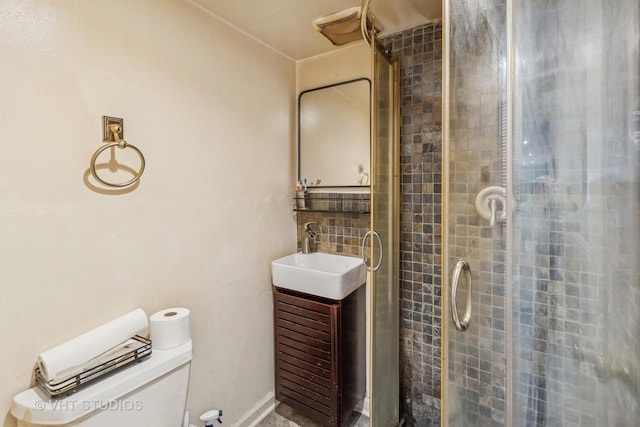 bathroom featuring vanity, an enclosed shower, and toilet