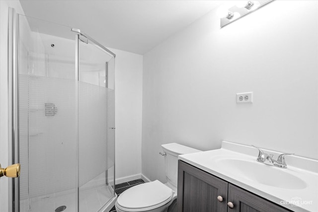 bathroom featuring vanity, walk in shower, and toilet