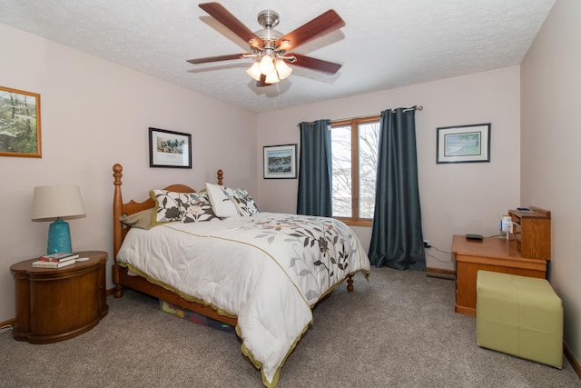 bedroom featuring a ceiling fan, baseboards, a textured ceiling, and carpet flooring