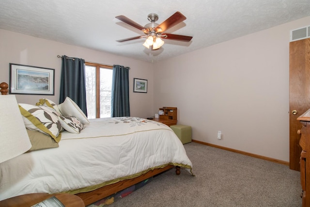 bedroom featuring visible vents, a textured ceiling, baseboards, and carpet