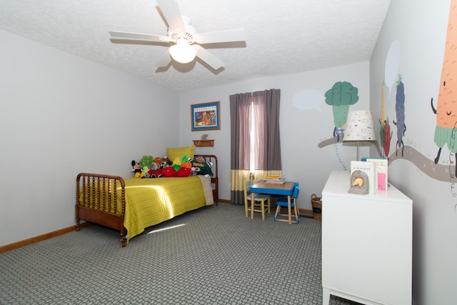 carpeted bedroom featuring baseboards, a textured ceiling, and ceiling fan