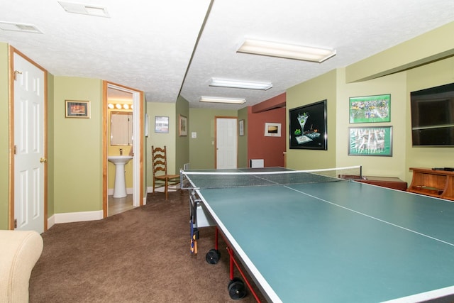 playroom with visible vents, dark carpet, a textured ceiling, and baseboards