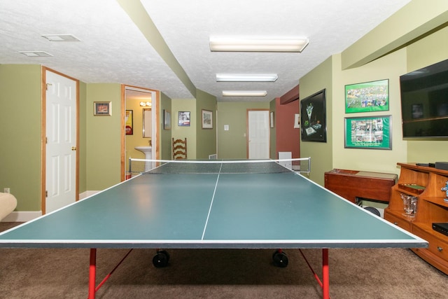 playroom with a textured ceiling and carpet