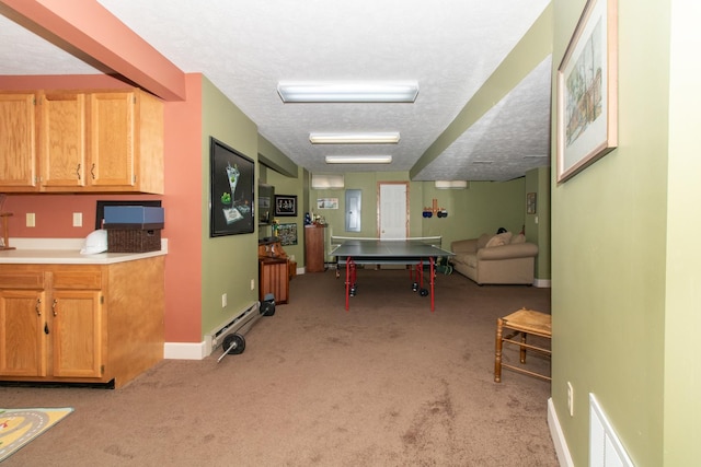 game room with visible vents, baseboards, light colored carpet, and a textured ceiling