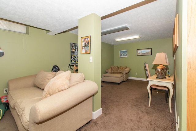 living area featuring carpet, baseboards, and a textured ceiling