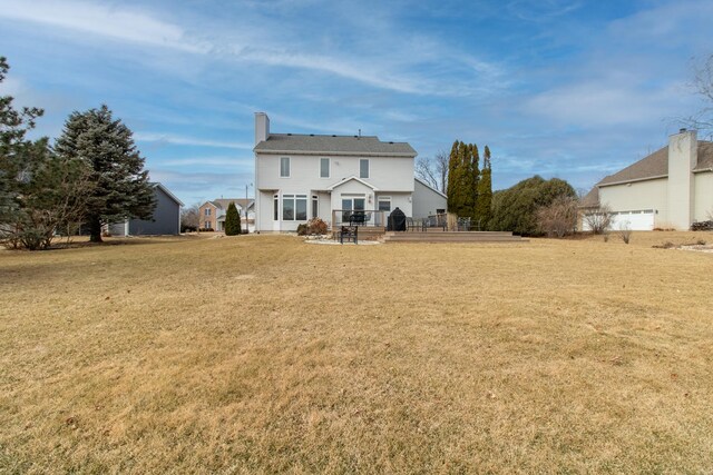 rear view of house featuring a yard