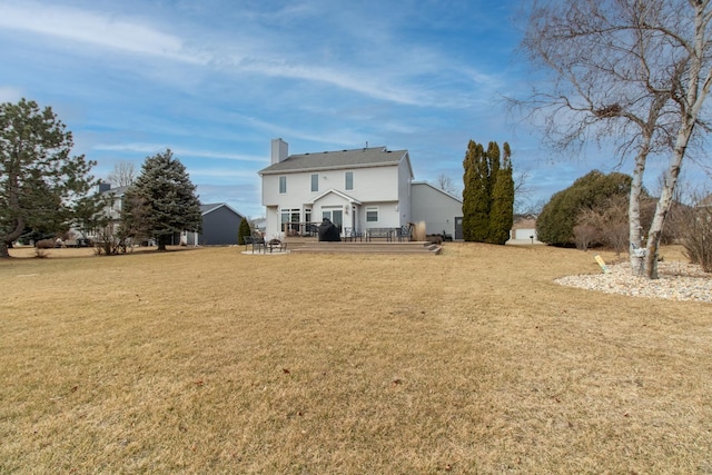 exterior space featuring a yard, a deck, and a chimney