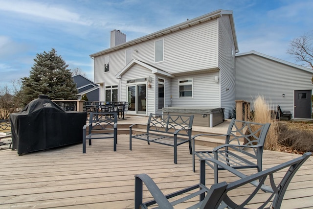 deck featuring area for grilling and a hot tub