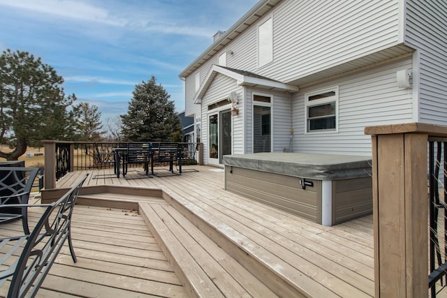 wooden deck featuring outdoor dining space and a hot tub