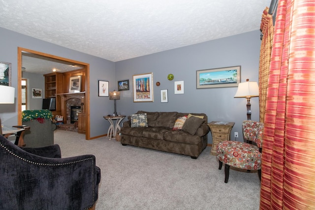 living area with carpet flooring, a fireplace, a textured ceiling, and baseboards