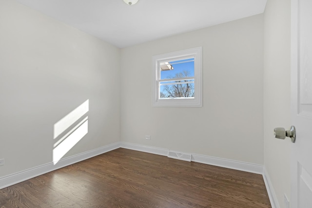 unfurnished room featuring dark wood-type flooring