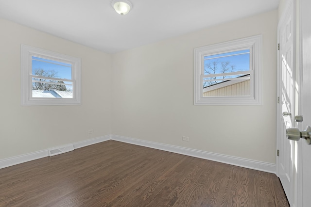 spare room featuring dark wood-type flooring