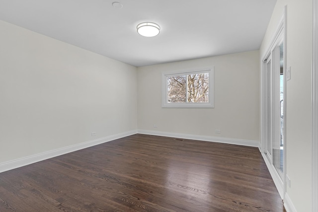 spare room with dark hardwood / wood-style floors