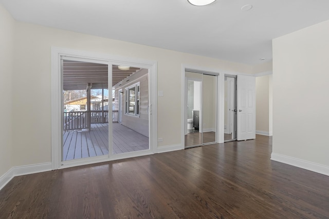 empty room with dark hardwood / wood-style floors