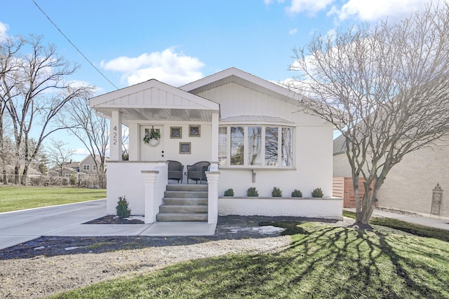 bungalow-style house featuring a porch and a front yard